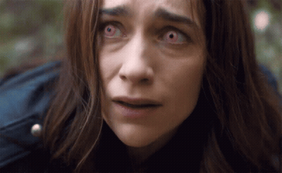 Woman With Red Eyes Looking At Camera GIF