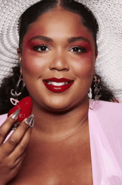 Woman With Red Eyeshadow And Red Lipstick Holding Strawberry GIF