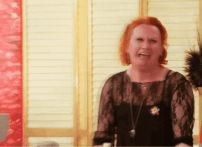 Woman With Red Hair And Black Lace Top Laughing GIF
