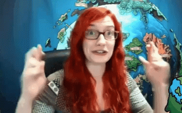 Woman With Red Hair And Glasses Making Funny Face GIF