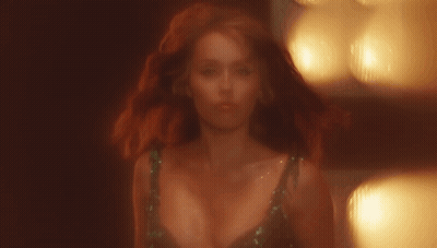 Woman With Red Hair And Plunging Neckline GIF
