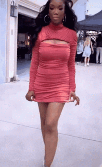 Woman With Red Hair And White Pants In Dark Room GIF