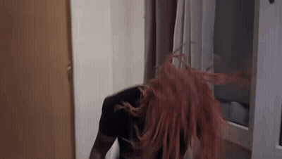 Woman With Red Hair Blowing In Wind By Window GIF