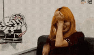 Woman With Red Hair Covering Face GIF