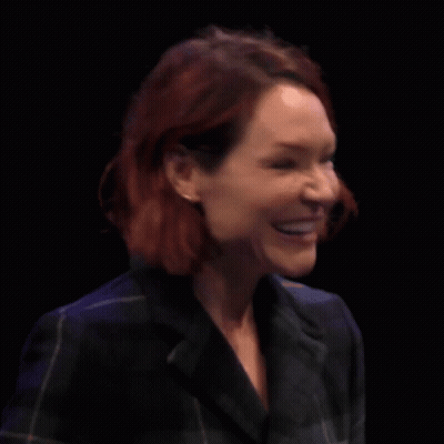 Woman With Red Hair Crosses Fingers GIF