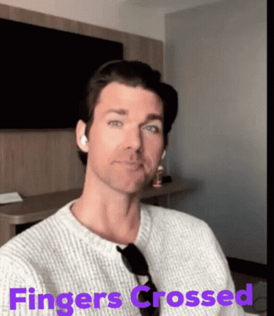 Woman With Red Hair Crosses Fingers GIF