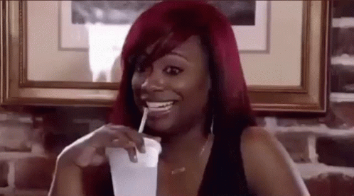 Woman With Red Hair Drinking Through Straw GIF