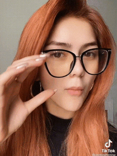 Woman With Red Hair Glasses And Black Turtleneck GIF