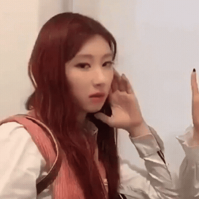 Woman With Red Hair Hand To Ear GIF