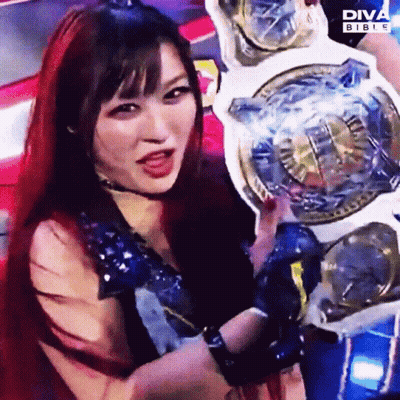Woman With Red Hair Holding Diva Bible Championship Belt GIF