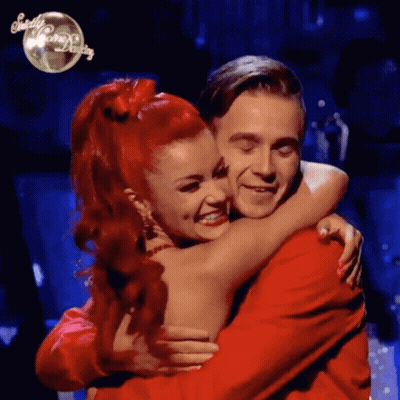 Woman With Red Hair Hugging Man GIF