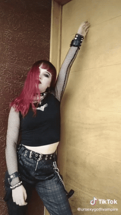 Woman With Red Hair In Black Crop Top And Pants GIF