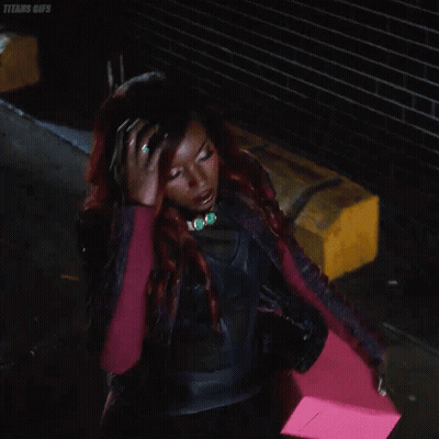 Woman With Red Hair In Black Leather Jacket Holding Pink Item GIF