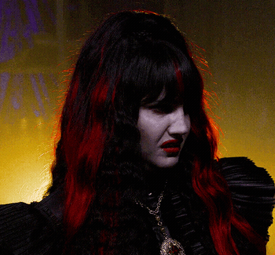 Woman With Red Hair In Black Top And Necklace GIF