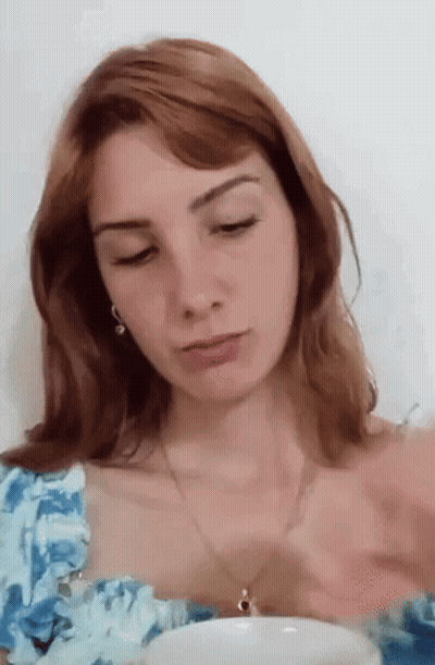 Woman With Red Hair In Blue And White Floral Top GIF