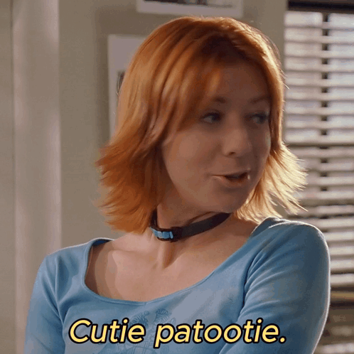 Woman With Red Hair In Blue Shirt Says Cutie Patootie GIF