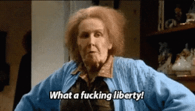 Woman With Red Hair In Blue Sweater Saying What A Fucking Liberty GIF