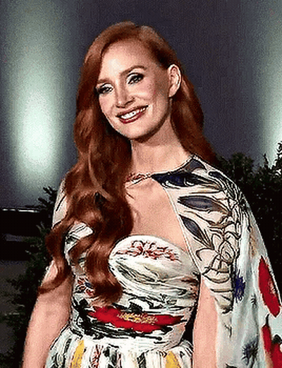 Woman With Red Hair In Floral Dress Smiling GIF