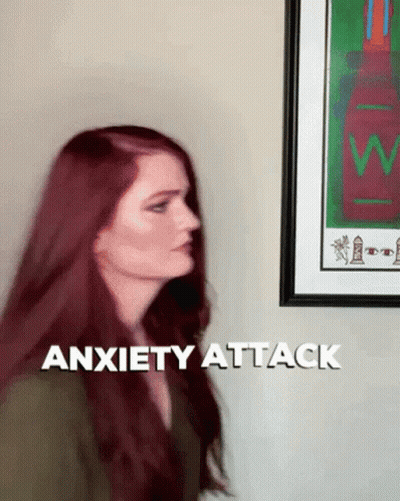 Woman With Red Hair In Front Of Anxiety Attack Sign GIF