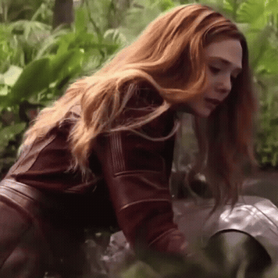 Woman With Red Hair In Leather Jacket Kneeling GIF