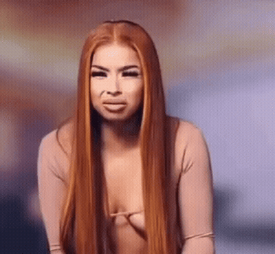 Woman With Red Hair In Revealing Top Making Funny Face GIF