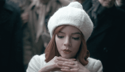 Woman With Red Hair In White Hat And Coat GIF