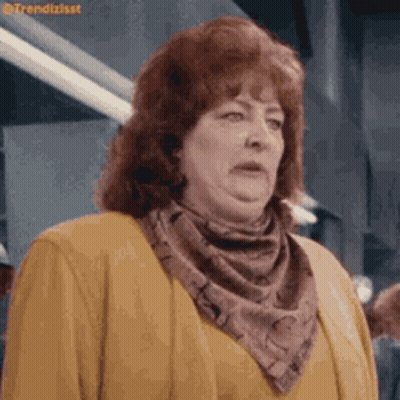 Woman With Red Hair In Yellow Sweater And Scarf GIF