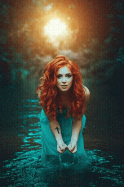 Woman With Red Hair Kneeling In Water GIF
