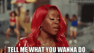 Woman With Red Hair Saying Tell Me What You Wanna Do In Front Of Group GIF
