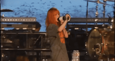 Woman With Red Hair Singing Into Megaphone GIF