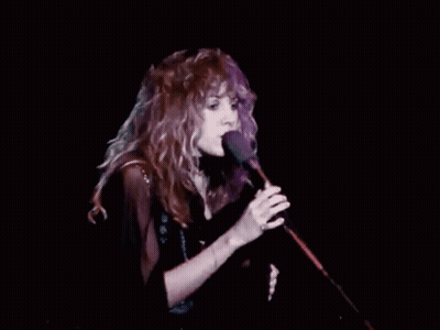 Woman With Red Hair Singing Into Microphone GIF
