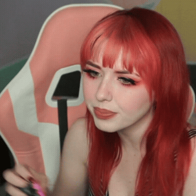 Woman With Red Hair Sitting In Pink Chair GIF