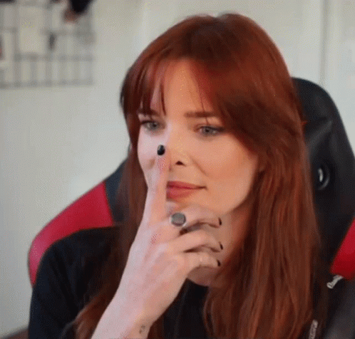 Woman with Red Hair Sitting in Red and Black Chair