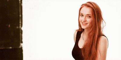 Woman With Red Hair Smiling In Black Top GIF