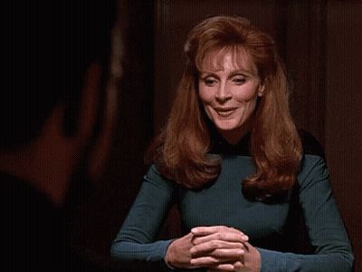 Woman With Red Hair Smiling In Blue Top GIF