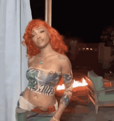 Woman With Red Hair Standing In Front Of Fire GIF