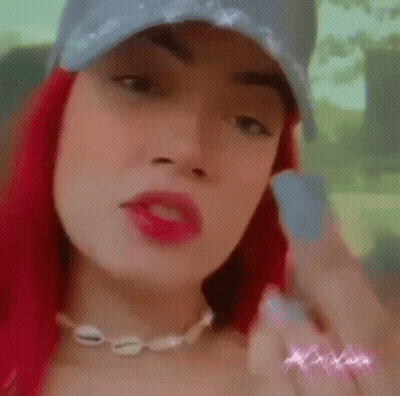 Woman With Red Hair Wearing Hat And Necklace GIF