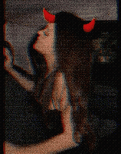 Woman With Red Horns And Cross On Face GIF