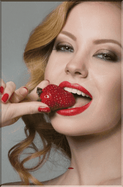 Woman With Red Lips And Nails Eating Strawberry With Vice On Nails GIF