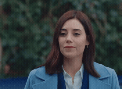 Woman With Red Lipstick And Brooch On Coat GIF