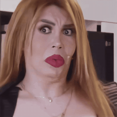 Woman With Red Lipstick And Necklace Making Funny Face GIF