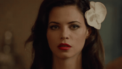 Woman With Red Lipstick And White Flower In Hair GIF