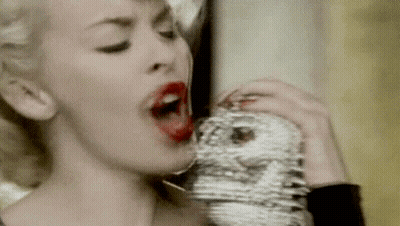 Woman With Red Lipstick Drinking From Face Glass GIF