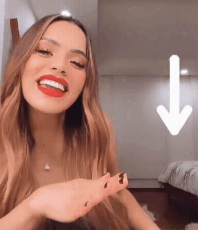 Woman With Red Lipstick Smiling With Down Arrow GIF