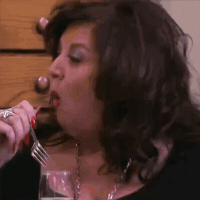 Woman With Red Nails Eating With Fork And Wine GIF