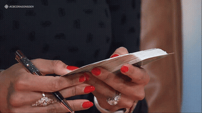 Woman With Red Nails Holding Pen and Paper