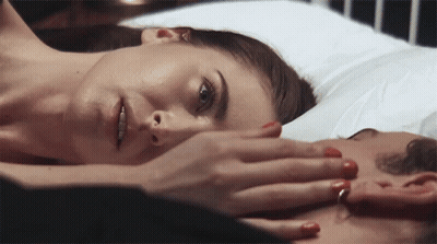 Woman With Red Nails Laying On Man's Chest GIF