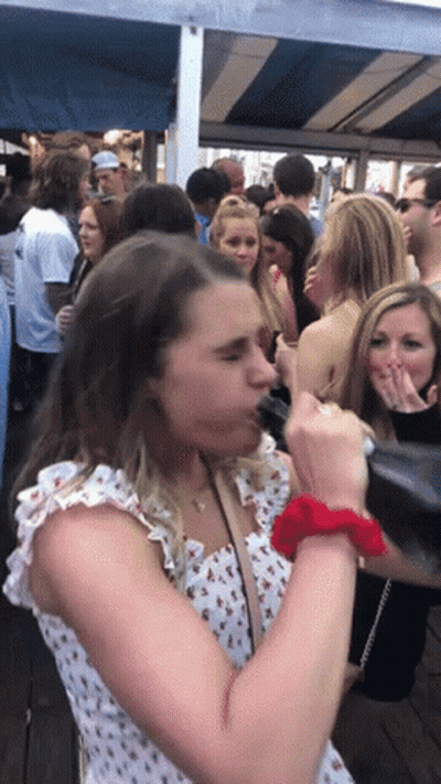 Woman With Red Scrunchie In Crowd GIF