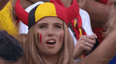 Woman With Red Yellow Black Horned Hat And Painted Faces GIF
