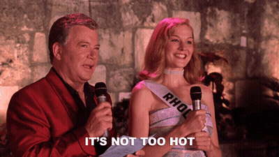 Woman With Rhol Sash Next To Man Holding Microphones GIF